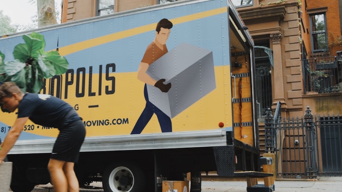 A moving truck being loaded outside an apartment building on moving day